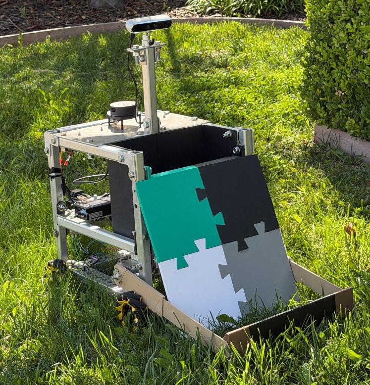 Completed LitterBot prototype outdoors, showing mecanum wheels, depth camera mast, LiDAR, and 3D-printed collection ramp.