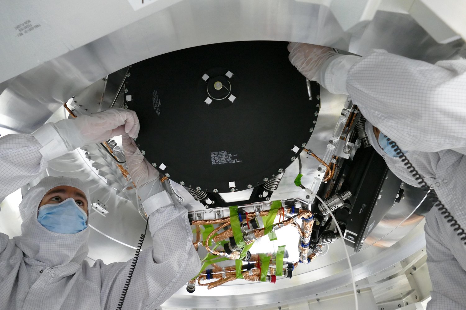 Technicians installing a reaction wheel on NASA's Europa Clipper spacecraft.