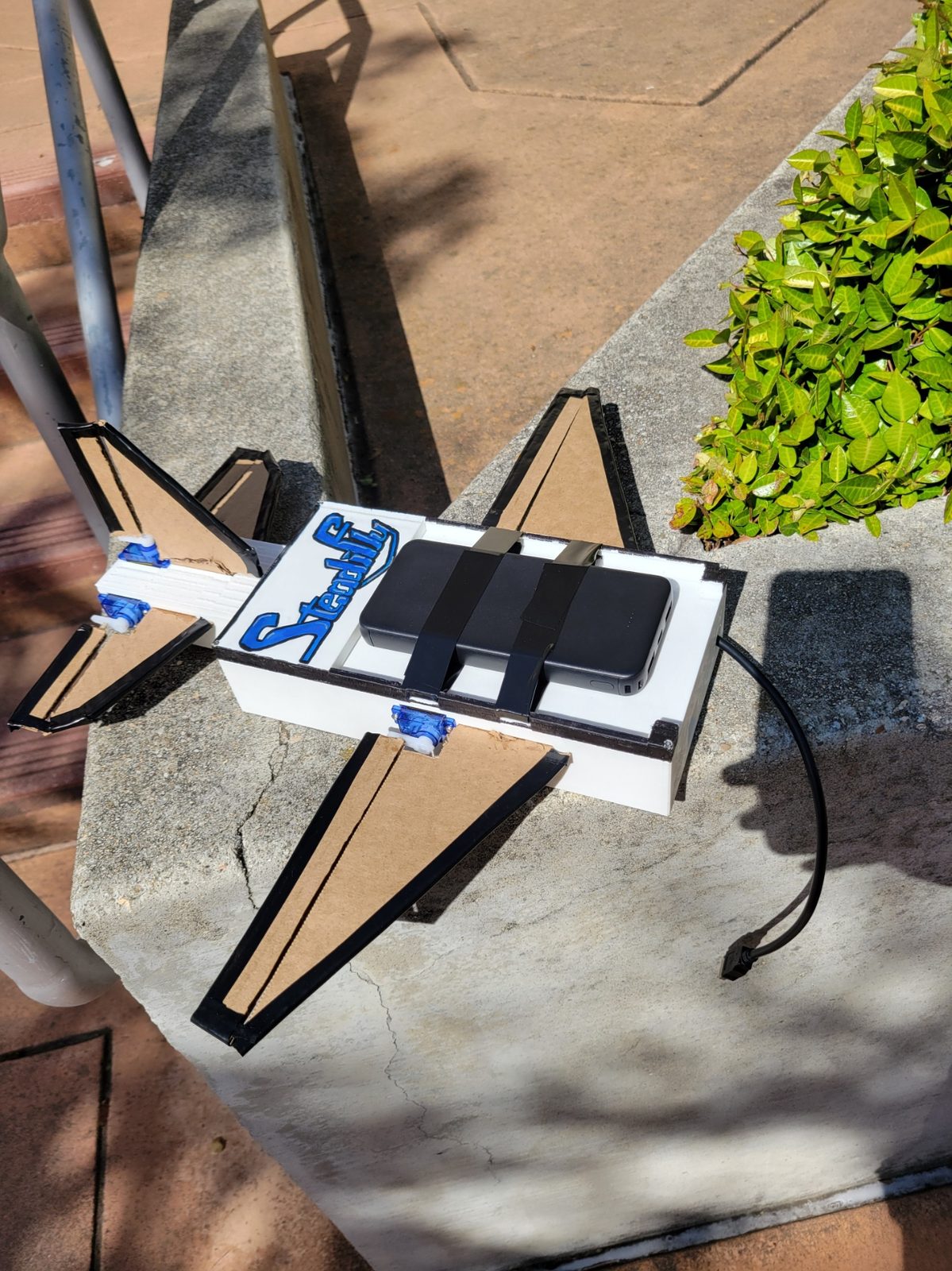 The SteadiFly airframe with servo-driven control surfaces and onboard battery.